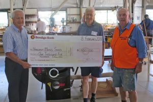 Photo of Nick Catania president the $1500 cheque to Lynton and Bill from the Shed